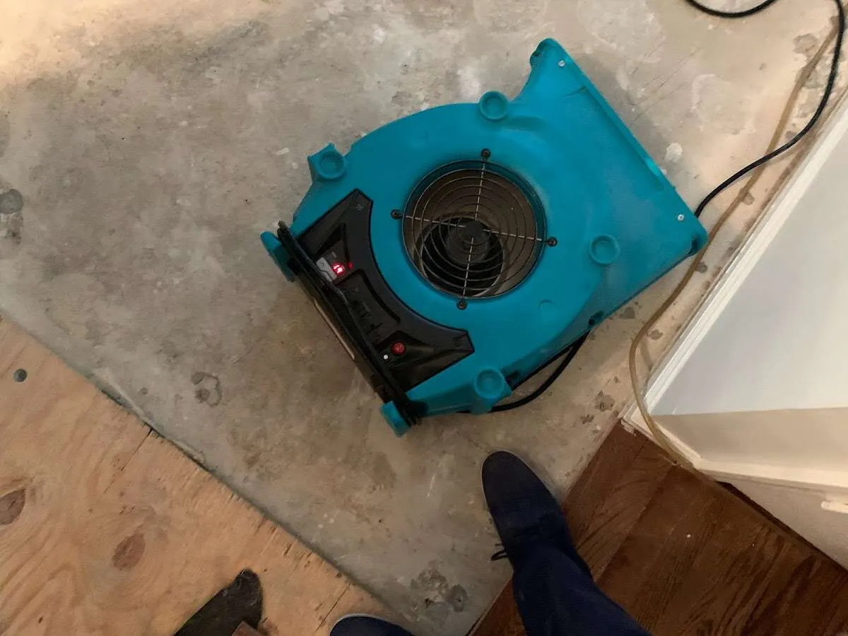 Air mover drying subfloor during Commercial Water Damage Restoration in Westwood Lakes